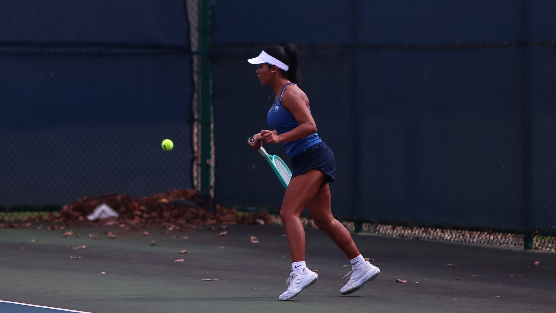 Alanna Reyes hitting a tennis ball