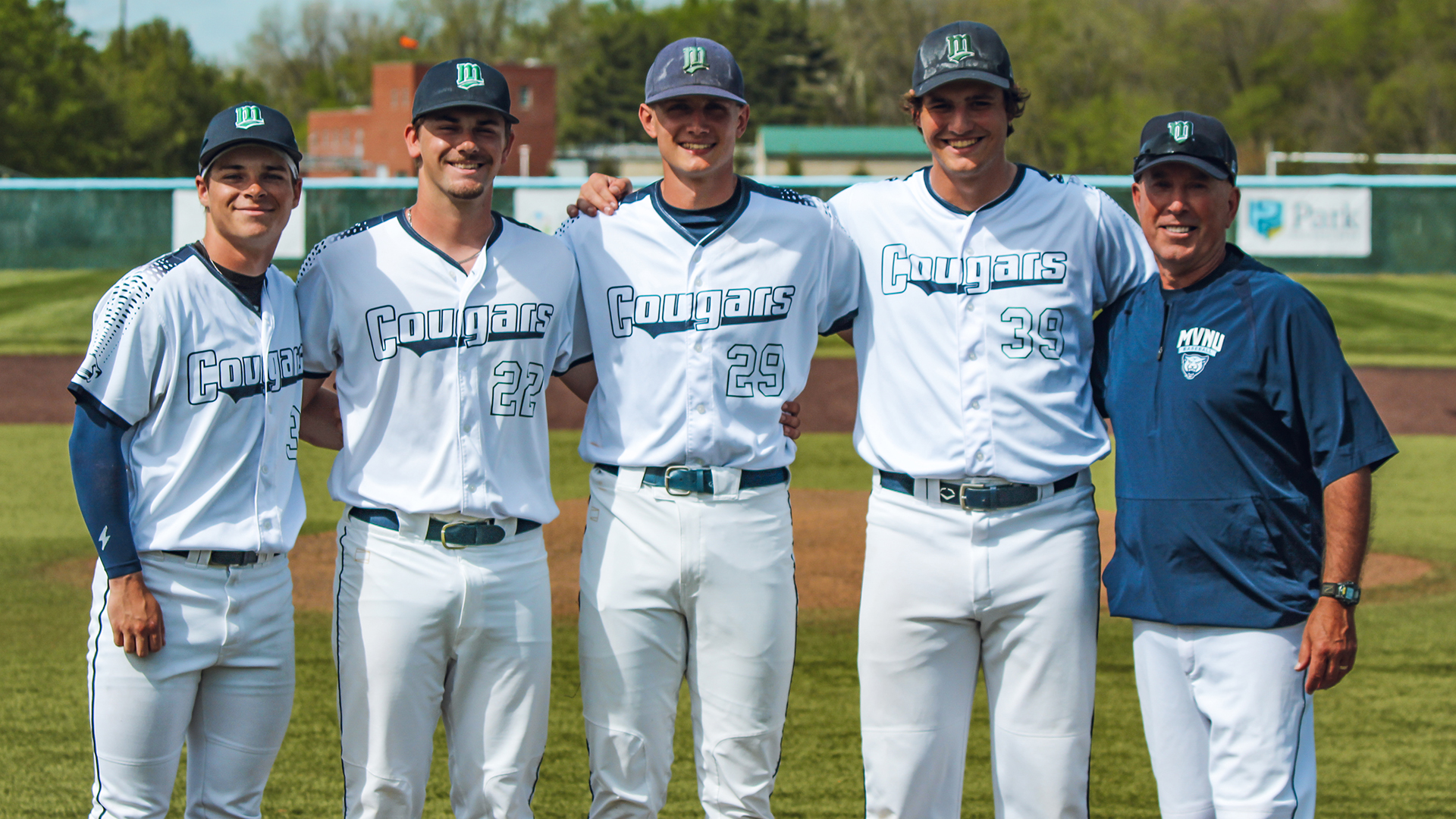 Baseball seniors Carter LaPata, Rider Minnick, Reese Willoughby, and Jared Hurbult stand for a photo with head coach Keith Veale.