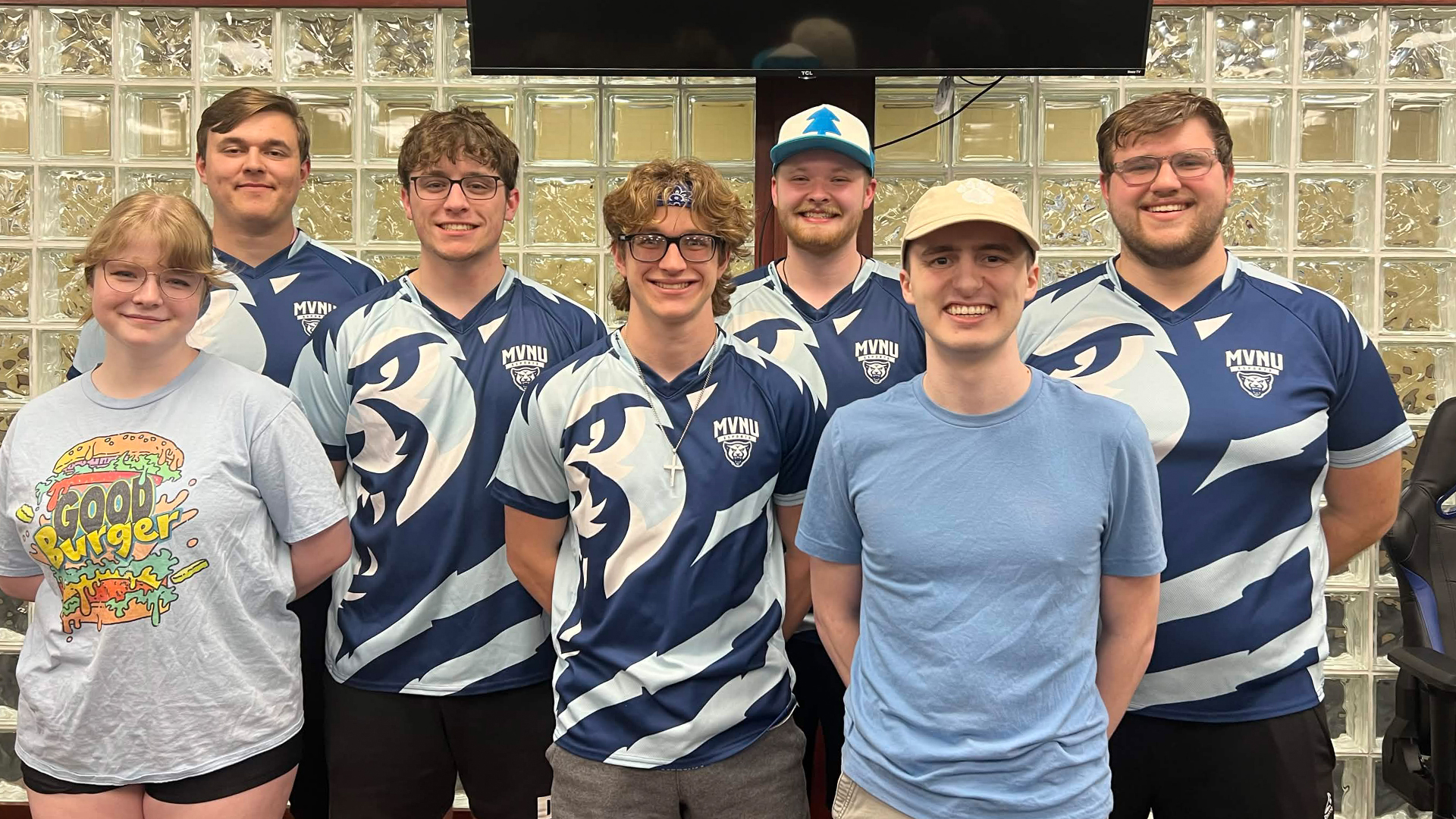 The overwatch team standing together and smiling after a big win