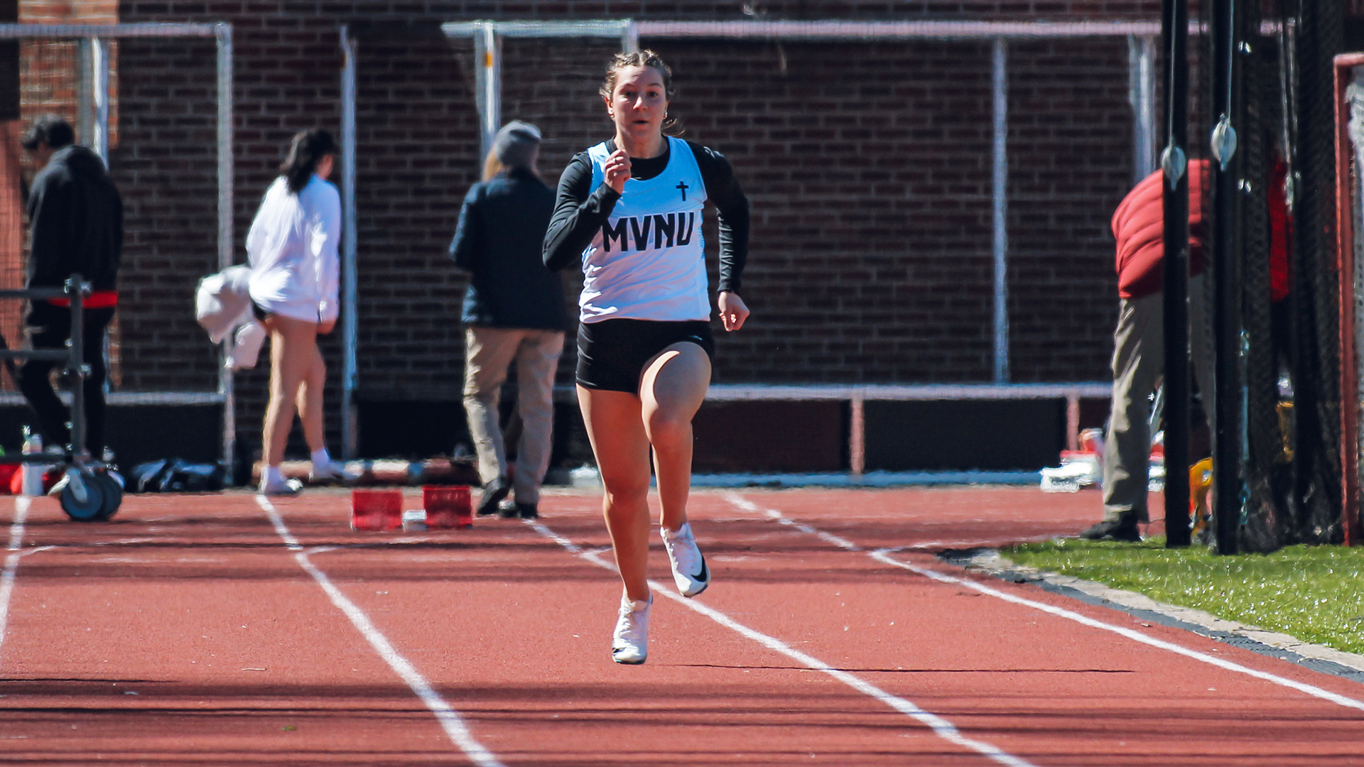 Maddy Lengacher runs a race at the track meet